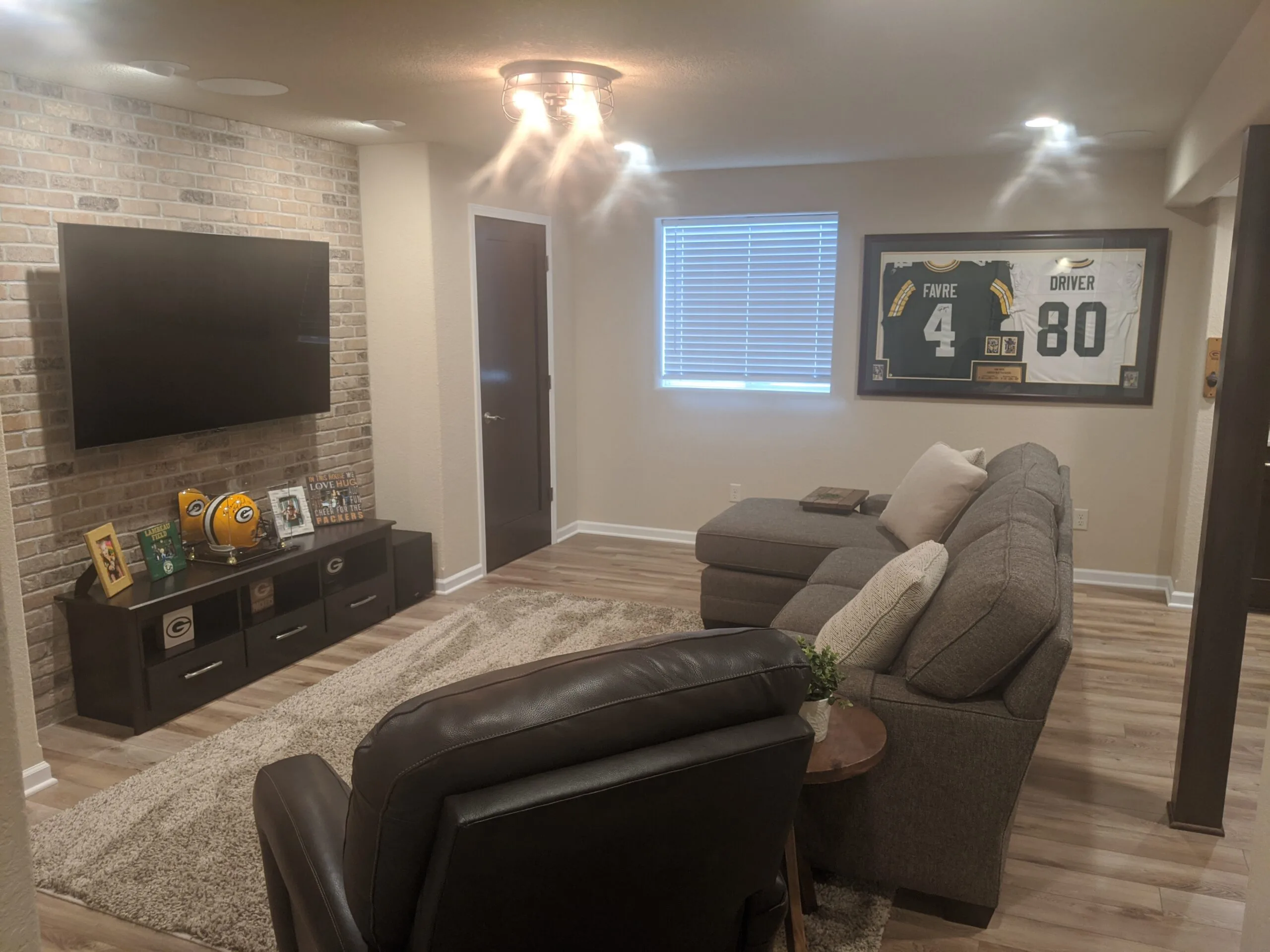 Basement family room with brick wall