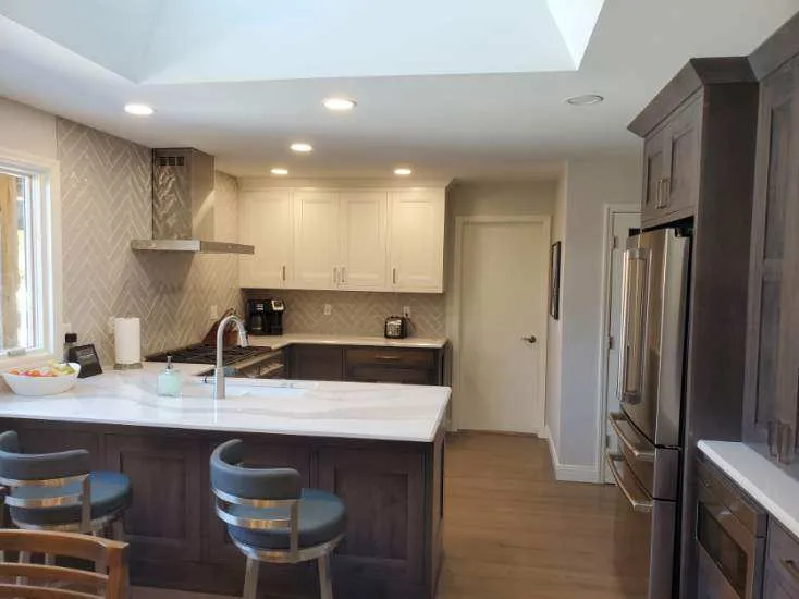 Two-tone kitchen with quartz peninsula
