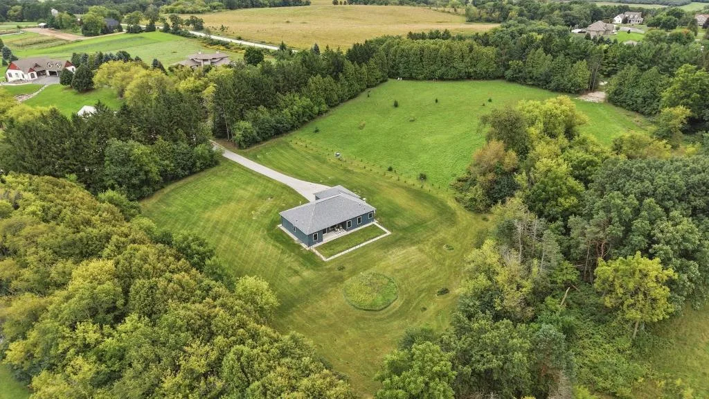 Aerial view of a custom home on a wooded Wisconsin lot