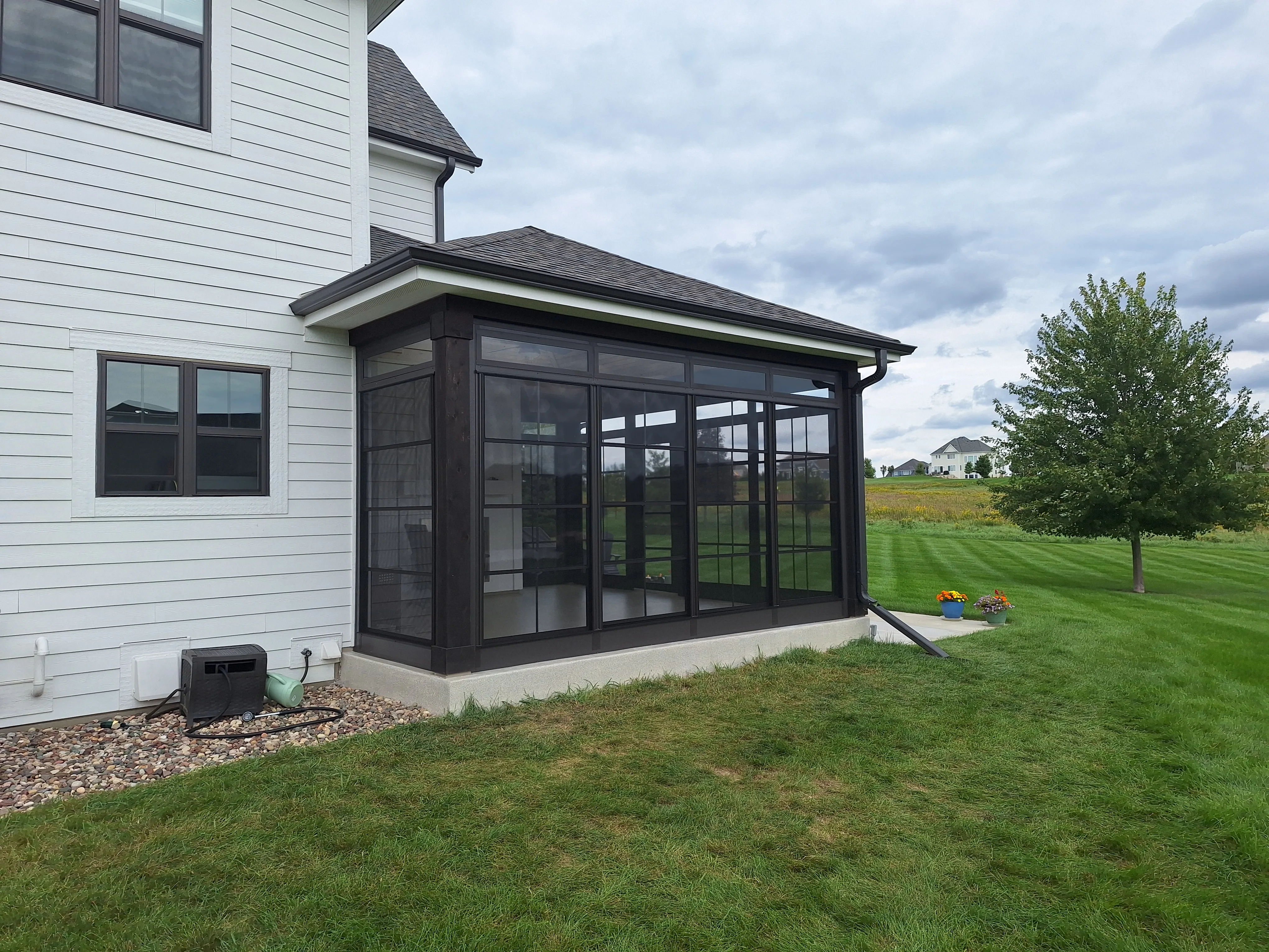 Side view of a screened porch addition with low-maintenance trim