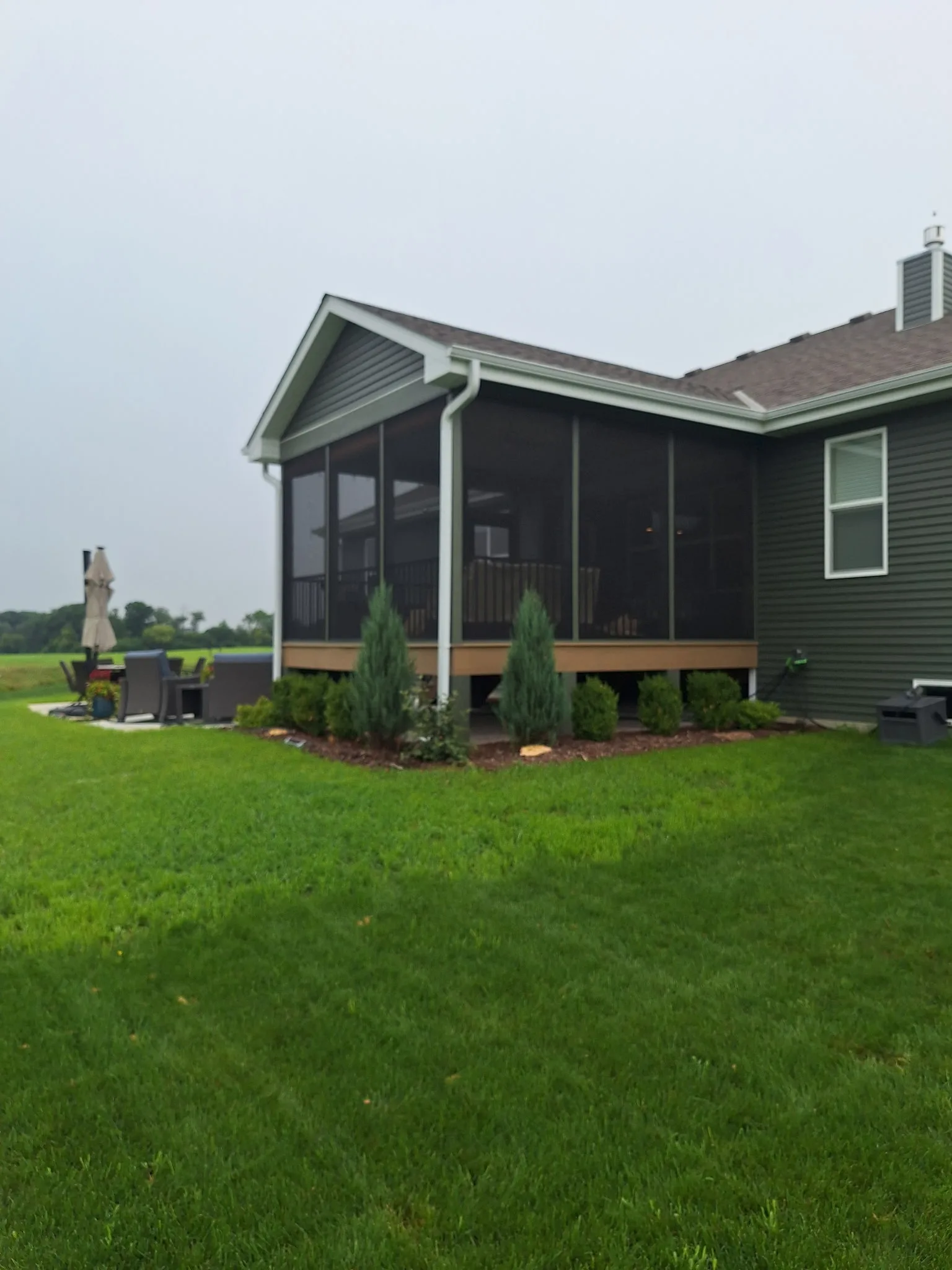 Raised screened porch from backyard